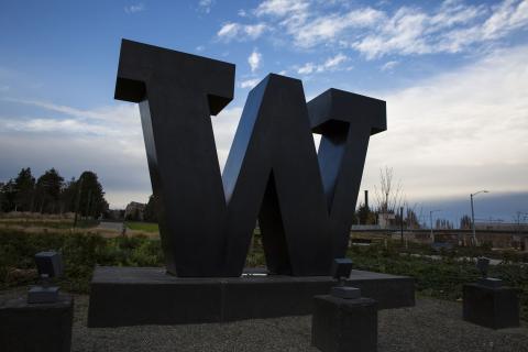 Bronze W statue on Rainier Vista with sky in the background