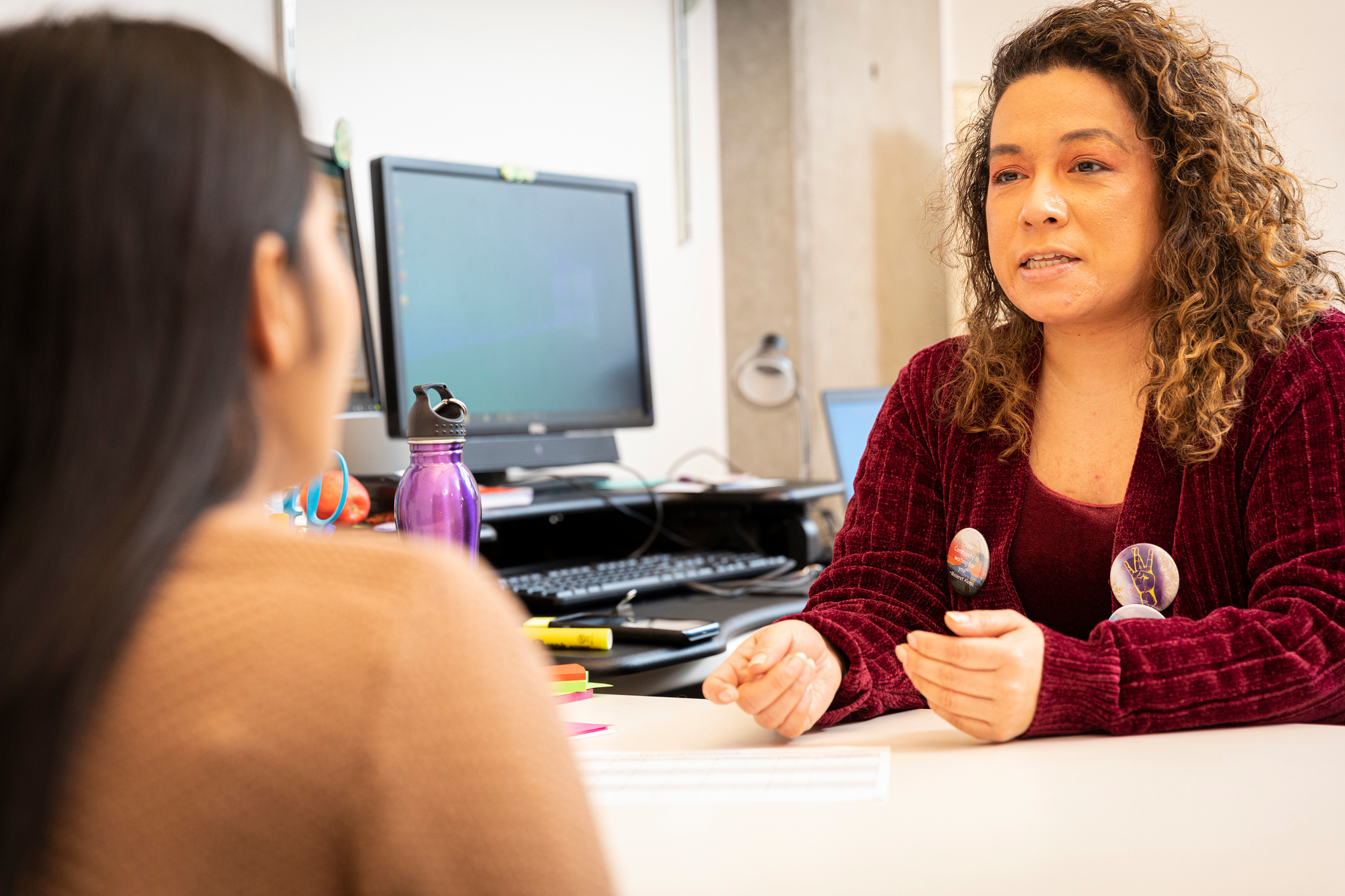 two people talking across a desk
