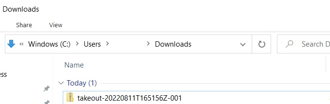 Windows Downloads folder displaying the zipped folder as the top item in the folder