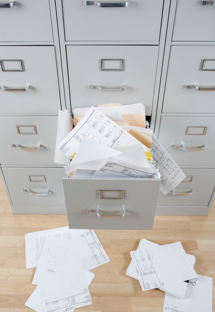 File drawer overflowing with paper
