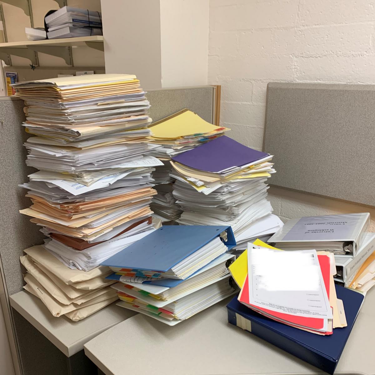 discarded ROT paper piles on desk